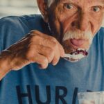 Eating - Man Wearing Blue Hurley Shirt