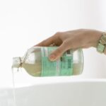 Skincare - Person Pouring Aromatic Soap On Water