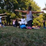 Wellness - Women Performing Yoga on Green Grass Near Trees