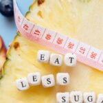 Less - Tape Measure and Letter Blocks on a Sliced Pineapple