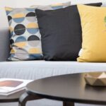 Home - Centerpiece on Coffee Table Beside Sofa With Three Pillows