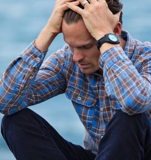 Stress - Man in Blue and Brown Plaid Dress Shirt Touching His Hair