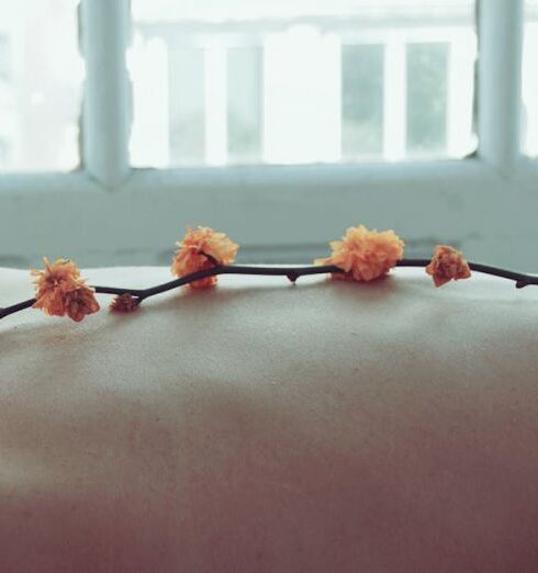 Wellness - Orange Petaled Flowers on Person's Back