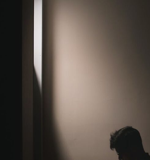 Books - A Man Reading Book while Sitting on a Bed