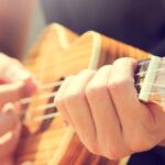 Hobby - Person Playing Brown Ukulele