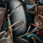 Belongings - Black and Brown Leather Bifold Wallet Beside Black Framed Eyeglasses