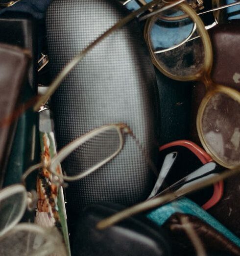 Belongings - Black and Brown Leather Bifold Wallet Beside Black Framed Eyeglasses