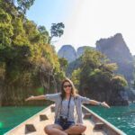 Travel - Photo of Woman Sitting on Boat Spreading Her Arms