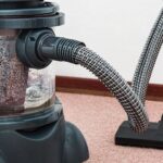 Household - Black and Red Canister Vacuum Cleaner on Floor