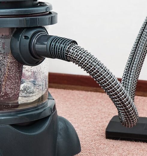 Household - Black and Red Canister Vacuum Cleaner on Floor