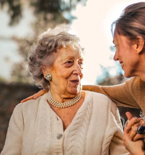 Care - Joyful adult daughter greeting happy surprised senior mother in garden