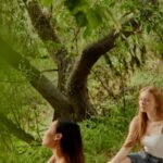 Foods - Women Having a Conversation while Sitting on a Picnic Blanket in the Park