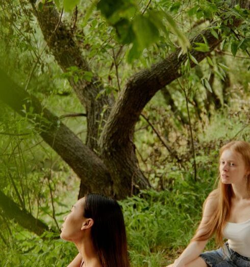 Foods - Women Having a Conversation while Sitting on a Picnic Blanket in the Park