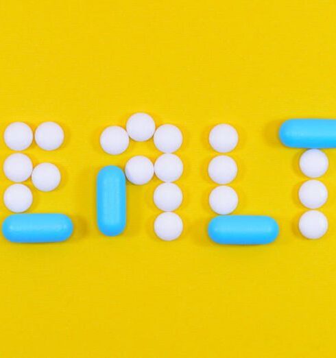 Health - White and Blue Health Pill and Tablet Letter Cutout on Yellow Surface