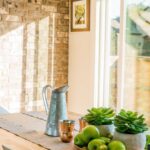 Home - Black Kettle Beside Condiment Shakers and Green Fruits and Plants on Tray on Brown Wooden Table