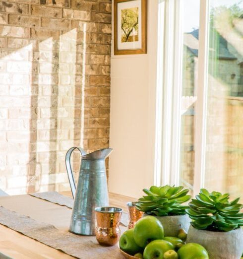 Home - Black Kettle Beside Condiment Shakers and Green Fruits and Plants on Tray on Brown Wooden Table