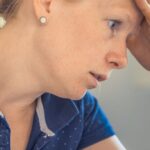 Anxiety - Woman Sitting in Front of the Laptop Computer in Shallow Photo