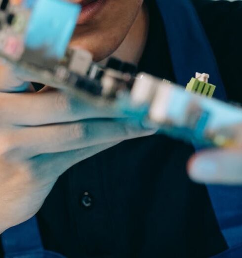 Microchipping - Close-up of a Man Looking at a Motherboard