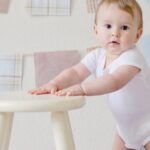 Baby - Baby Holding White Wooden Stool