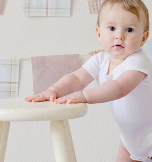 Baby - Baby Holding White Wooden Stool