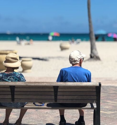 Retirement - Man and Woman Sitting on Brown Wooden Bench