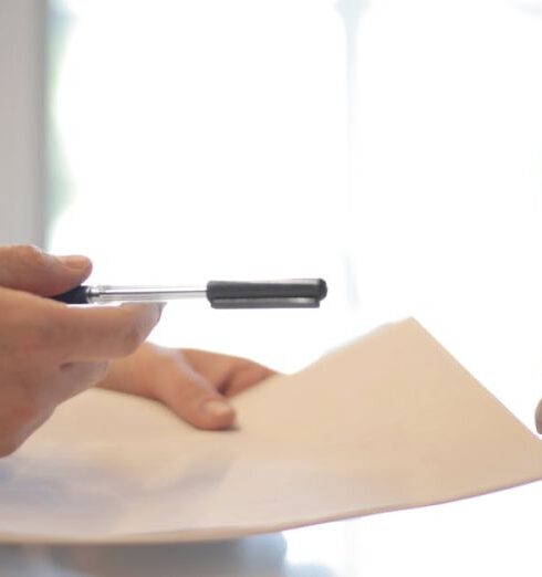 Loans - Crop businessman giving contract to woman to sign