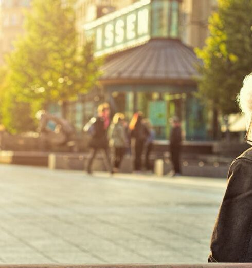 Retirement - Man Sitting on Wooden Bench Wearing Black Leather Jacket