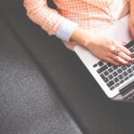 Plan - Person Sitting on Gray Sofa While Using Macbook