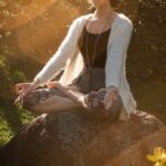 Wellness - Woman Meditating on Rock