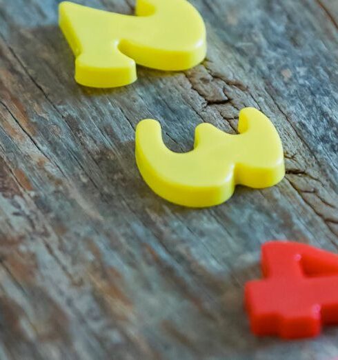 Tuition - Multicolored numbers for counting on wooden table