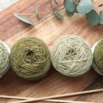 Knitting - Four Green Yarns on Chopping Board