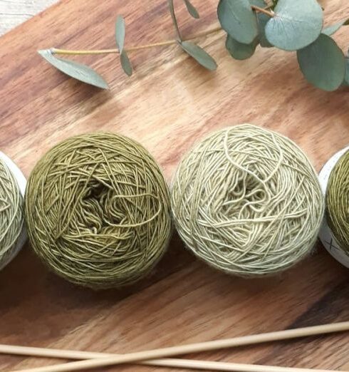 Knitting - Four Green Yarns on Chopping Board