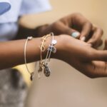 Jewelry - Selective Focus Photography of Person Wearing Three Bangles