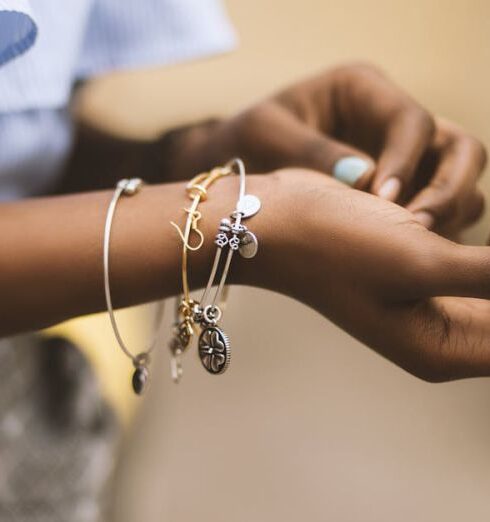 Jewelry - Selective Focus Photography of Person Wearing Three Bangles