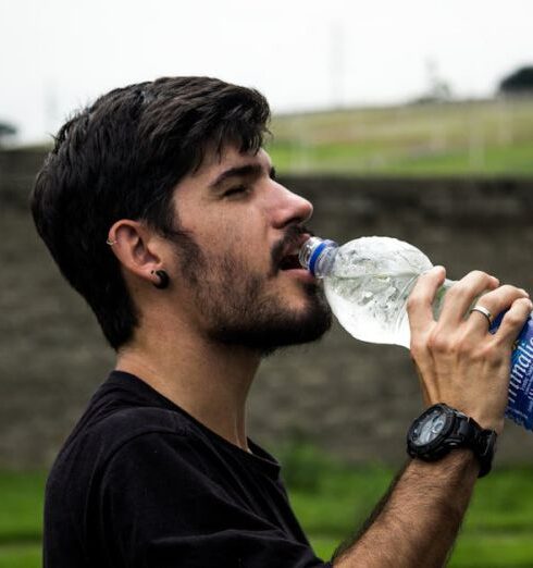 Drink Water - Man Wearing Black Shirt Drinking Water