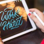 Lettering - Woman Holding White Tablet Computer