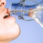 Drink Water - Woman Drinking Water From Glass Bottle