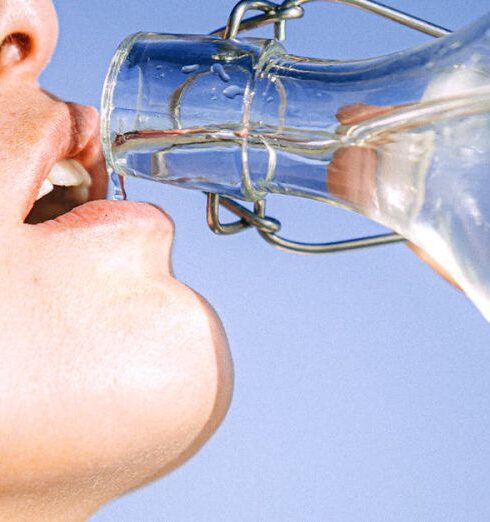 Drink Water - Woman Drinking Water From Glass Bottle