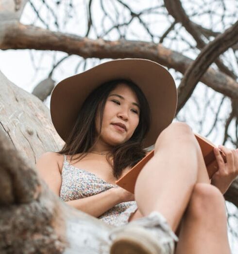 Books - A Woman Sitting on a Tree Branch