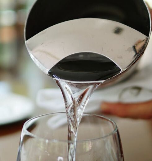 Drink Water - Person Pouring Water on Glass