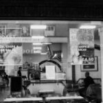 Meals - Chairs and Tables in Front of a Restaurant in Black and White