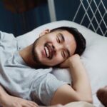 Bed - Two Men in Bed Looking at Each Other