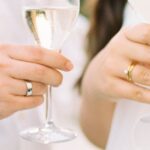 Interactions - Photograph of Wine Glasses in Mans and Womans Hands