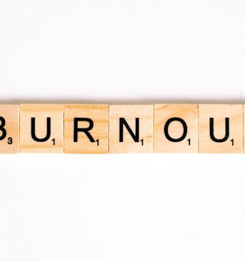 Burnout - Close-Up Shot of Scrabble Tiles on a White Surface