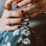 Drink Water - Person Sitting on Grey Sofa While Holding Clear Highball Glass of Water