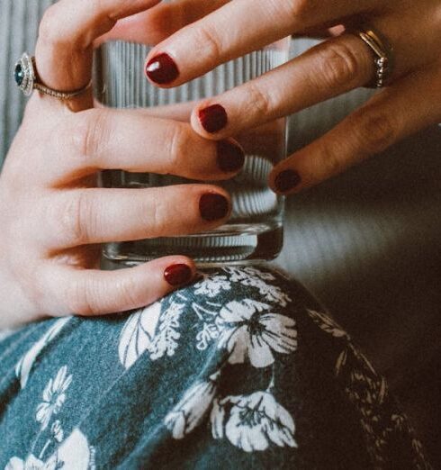 Drink Water - Person Sitting on Grey Sofa While Holding Clear Highball Glass of Water