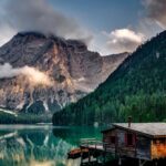 Nature - Mirror Lake Reflecting Wooden House in Middle of Lake Overlooking Mountain Ranges