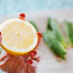 Detox - Selective Focus Photography of Person Holding Sliced Lemon