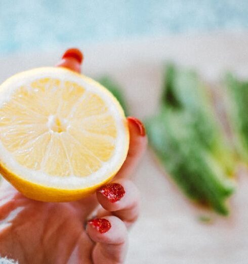 Detox - Selective Focus Photography of Person Holding Sliced Lemon