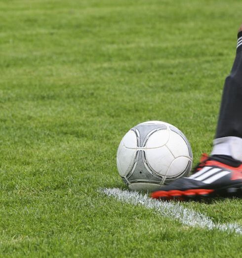 Hobbies - Soccer Player Kicking White Gray Soccer Ball on Green Grass Field